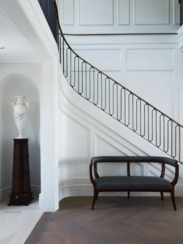 The staircase takes center stage

One of the home’s most striking features, the sweeping staircase brings a sense of movement to the entry while connecting the home’s more traditional architecture with a cleaner, contemporary point of view.

The beauty is in the details—the slender iron railing, dark wood handrail, crisp millwork, and the way the stair curves effortlessly into the upper level. Its scale is impressive, but the overall feeling remains light and understated.

It’s a beautiful example of the level of craftsmanship that went into the home, where even the grandest elements feel comfortable and considered.

General Contractor: @sbphomes 
Architecture: @mitchell_studio 
Interior Design: @dkda 
As seen in: @luxemagazine 
Photography: @timlenzphoto